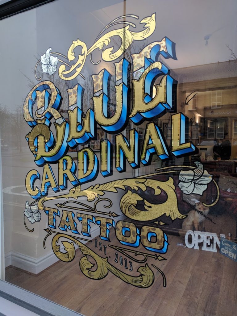 Blue Cardinal Tattoo gold leaf sign