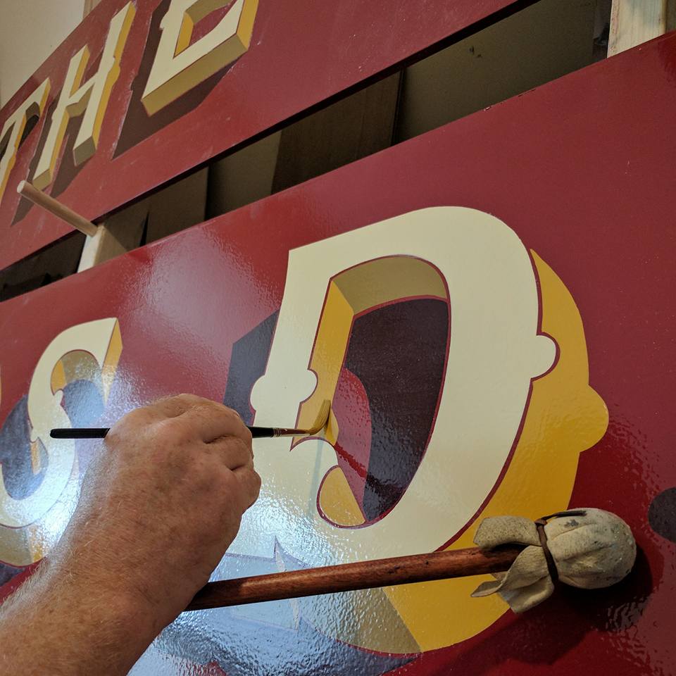 signwriting the butchers dog pub sign