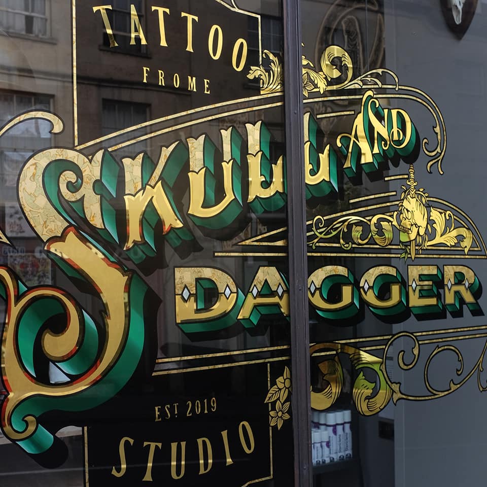 gold leaf tattoo shop sign - skull and dagger