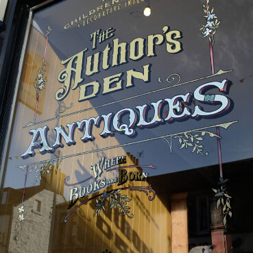 antiques window sign the authors den